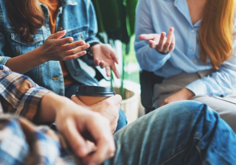 A group of young people sitting and talking together